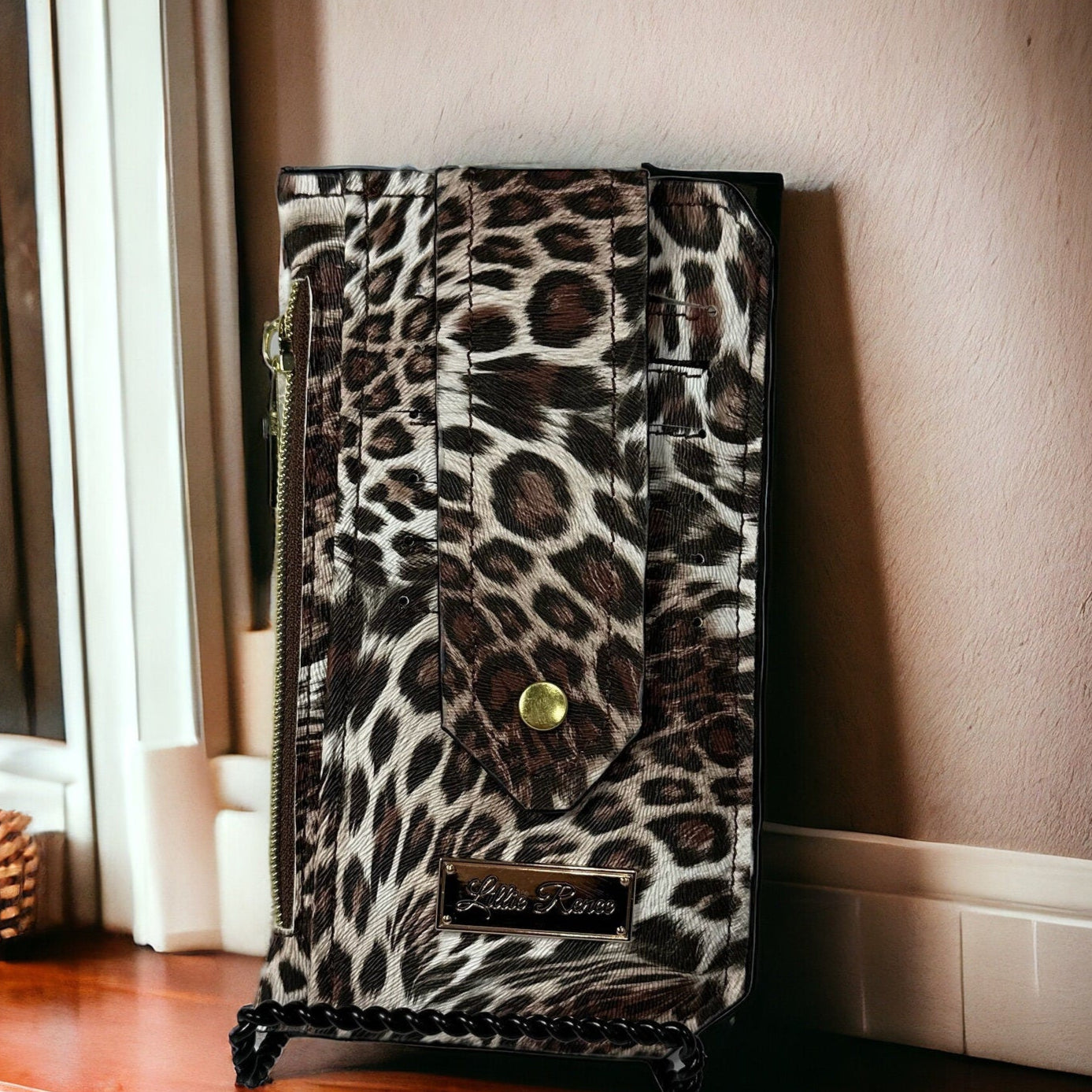 Brown leopard print vinyl Purse Pal slim wallet featuring six card slots secured with a snapped flap, a cash slip pocket, and a zippered coin pocket. Designed for both style and functionality, this compact wallet is accented with gold hardware for a chic, trendy look. Perfect for fashion lovers who want a sleek and stylish way to carry essentials.