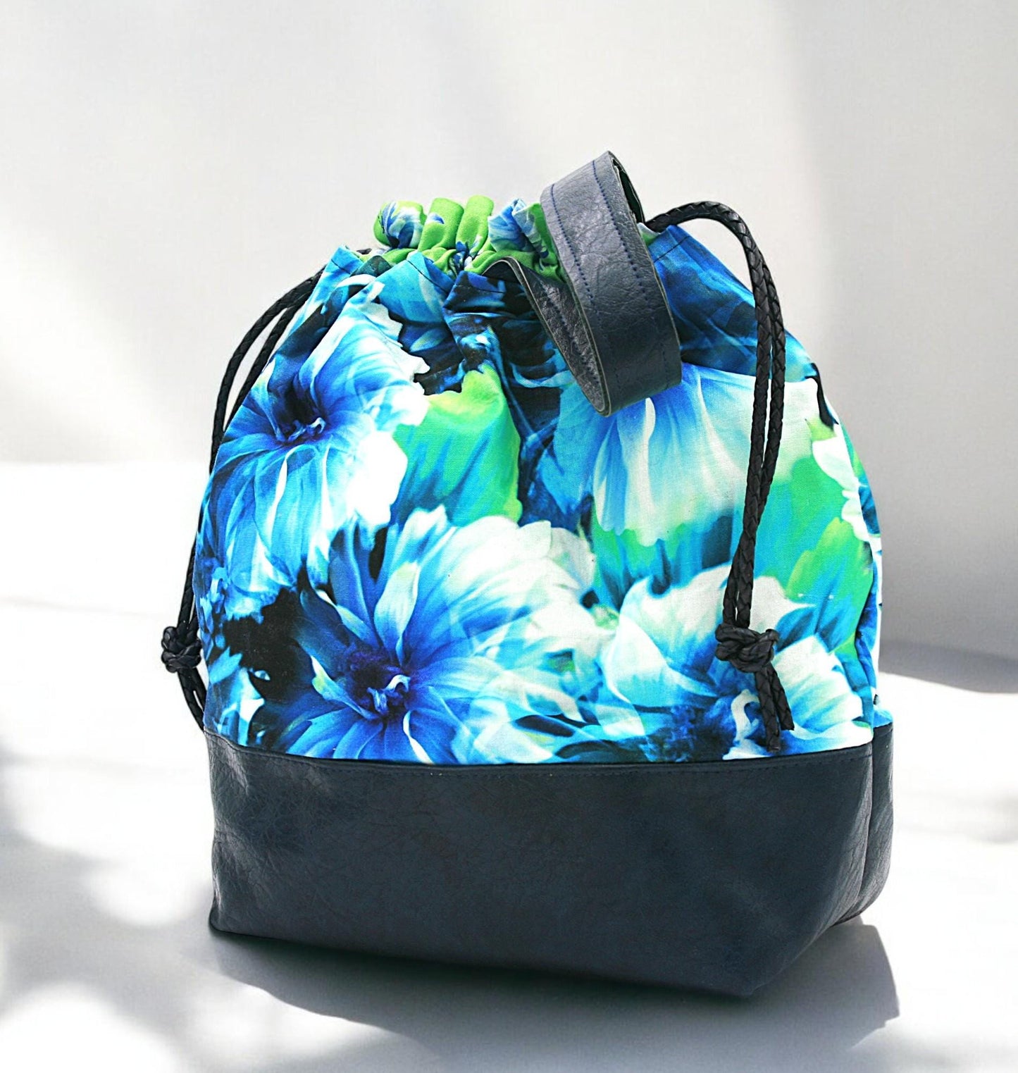 Floral Bloom Drawstring Bucket Bag in floral cotton with navy faux leather – handcrafted bag with 6 interior pockets