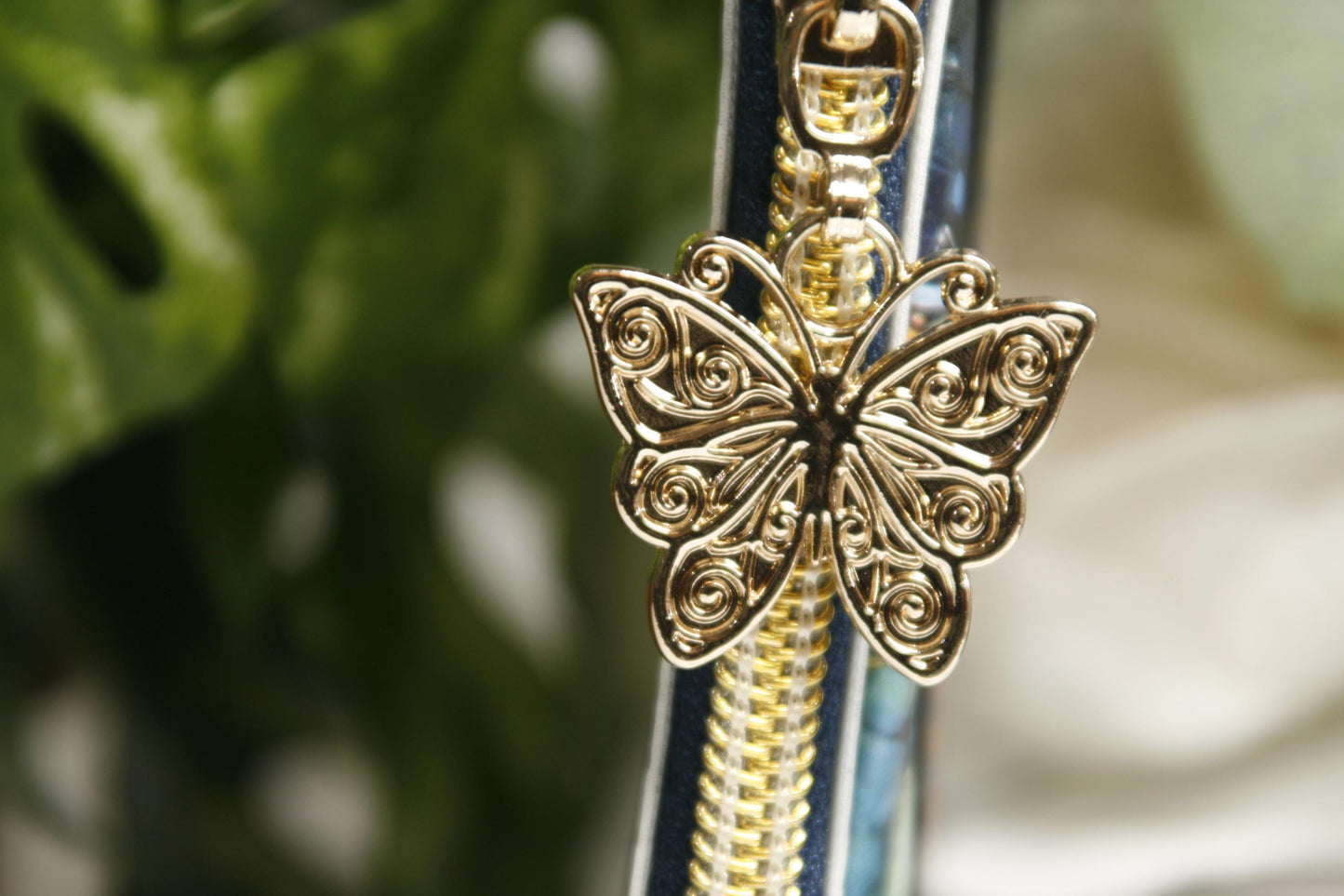 gold butterfly zipper pull on slim wallet