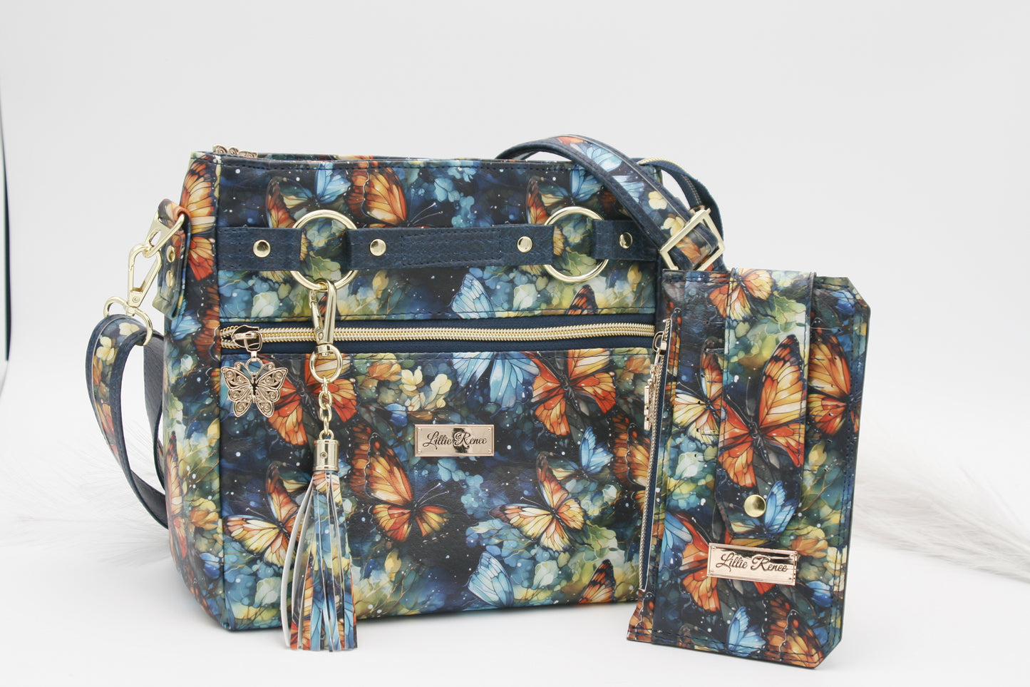 Add a touch of artistic beauty and practicality to your wardrobe with the Watercolor Butterfly Crossbody Bag. Designed for style-conscious women, this lightweight, hands-free purse combines fashion and functionality with a stunning watercolor butterfly print in shades of blue and orange with accents of gold