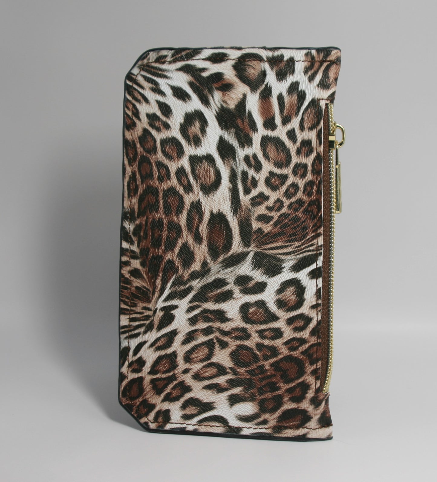 Brown leopard print vinyl Purse Pal slim wallet featuring six card slots secured with a snapped flap, a cash slip pocket, and a zippered coin pocket. Designed for both style and functionality, this compact wallet is accented with gold hardware for a chic, trendy look.