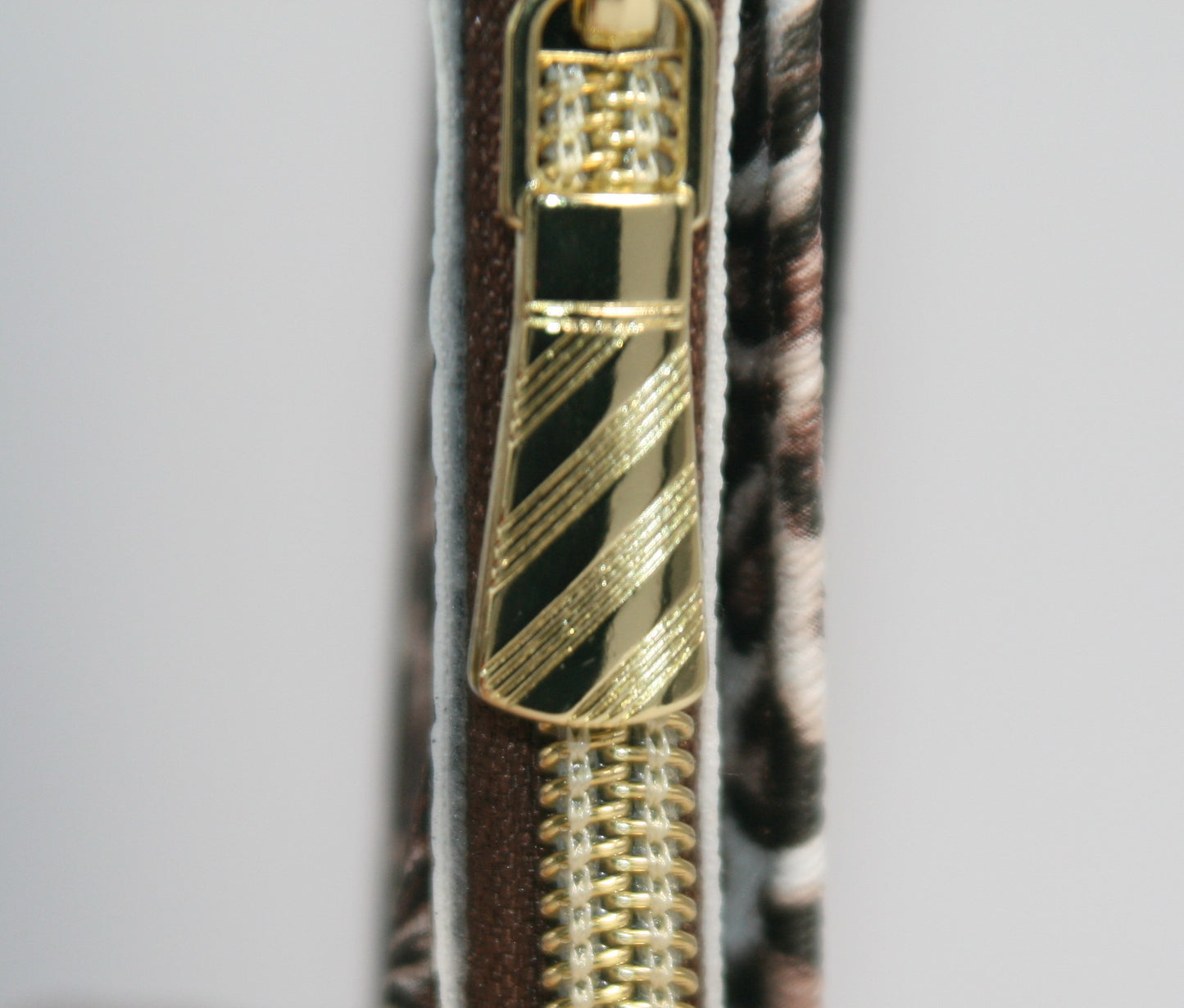 Designed for both style and functionality, this compact wallet is accented with gold hardware for a chic, trendy look.
