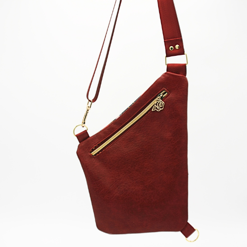 back f the sling is made of a beautiful
burgundy faux leather. the Back zipper pocket – Securely store valuables like your wallet, ID, or travel documents.