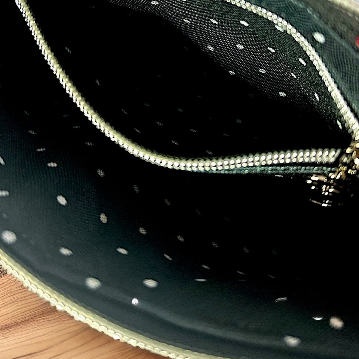 Black Leopard Print Crossbody Bag with Black Faux Leather Exterior, Water-Resistant Canvas Interior, and Secure Zipper Closures with Heart Zipper Pulls.