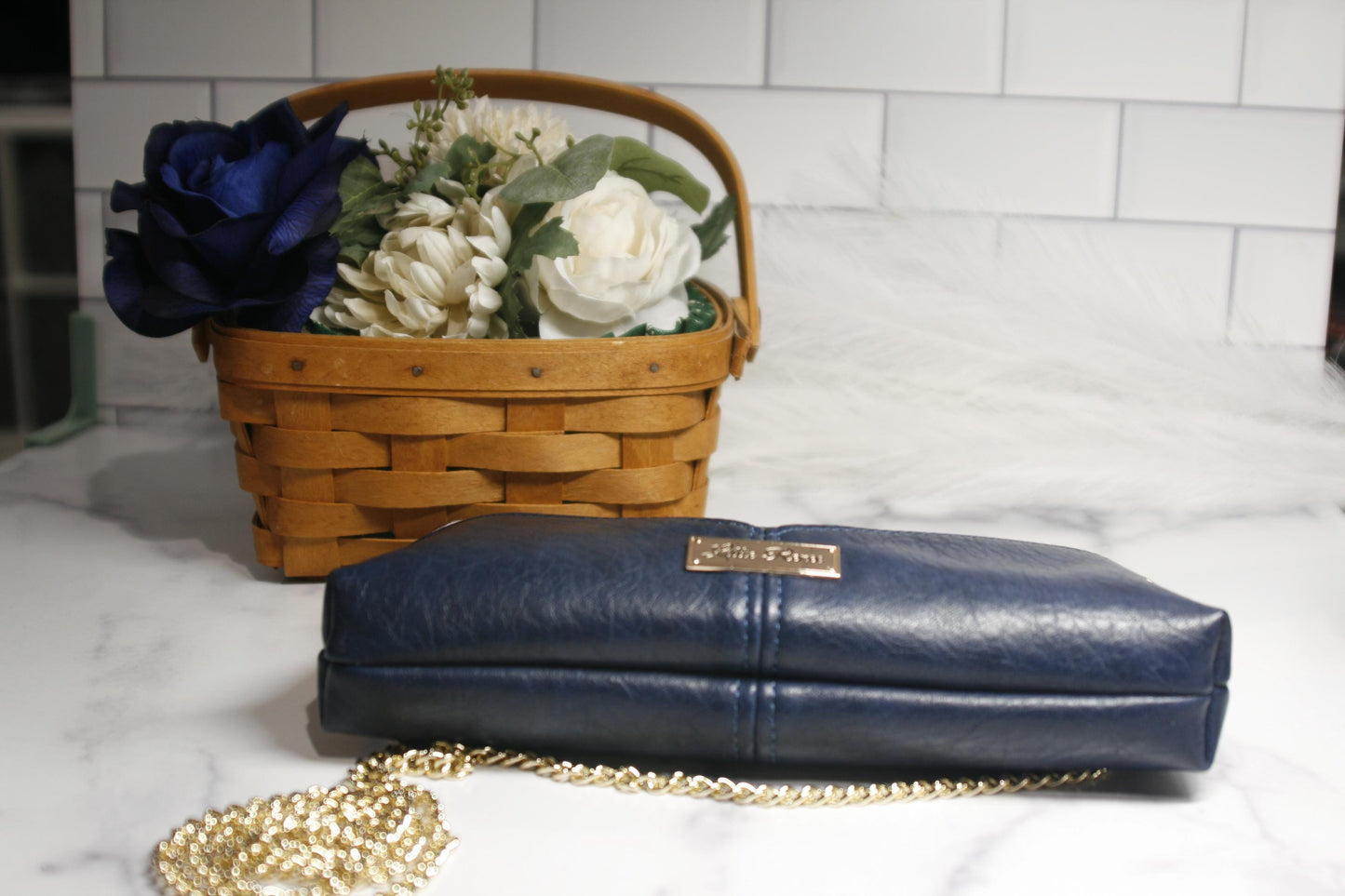 gold chain and bottom of blue purse