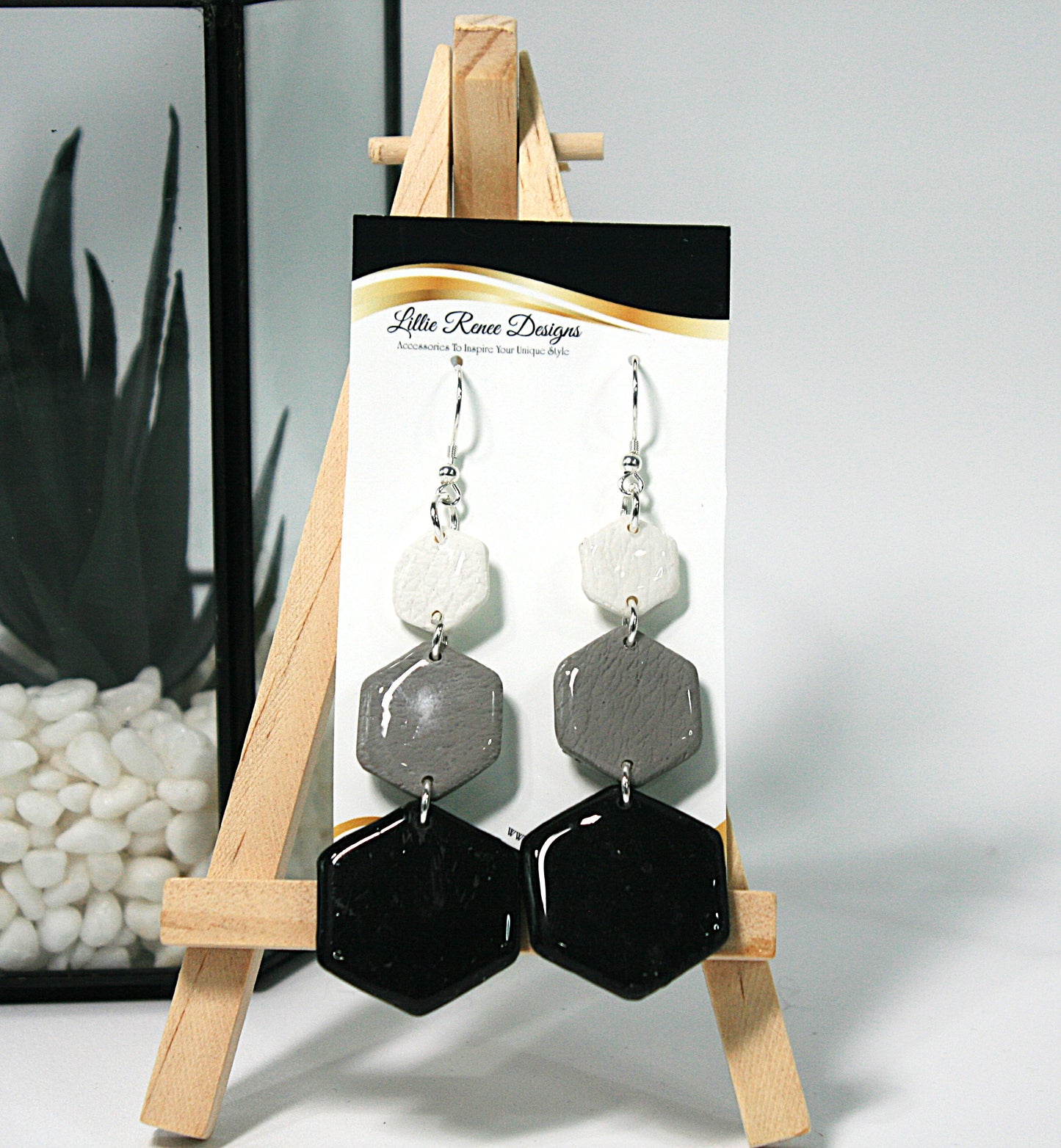 Close-up of handmade clay earrings with glossy finish.