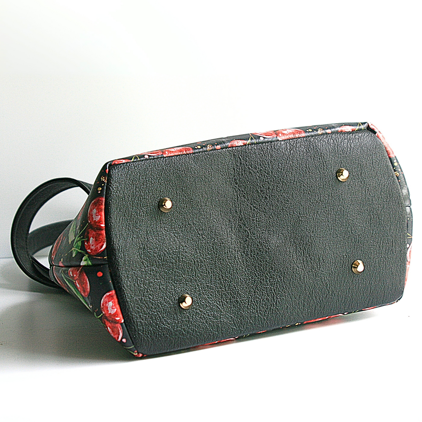 "Lola shoulder bag in exclusive cherry jubilee vinyl with cherry-printed waterproof lining and gold purse feet"
