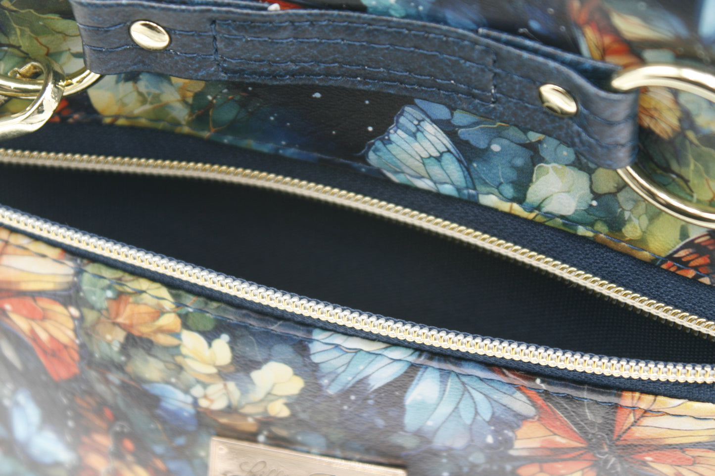 Front zipper pocket with tassel accent – Stylish and functional for quick access to essentials.
