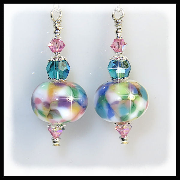 close up of the artisan pastel pink turquoise and purple lampwork earrings