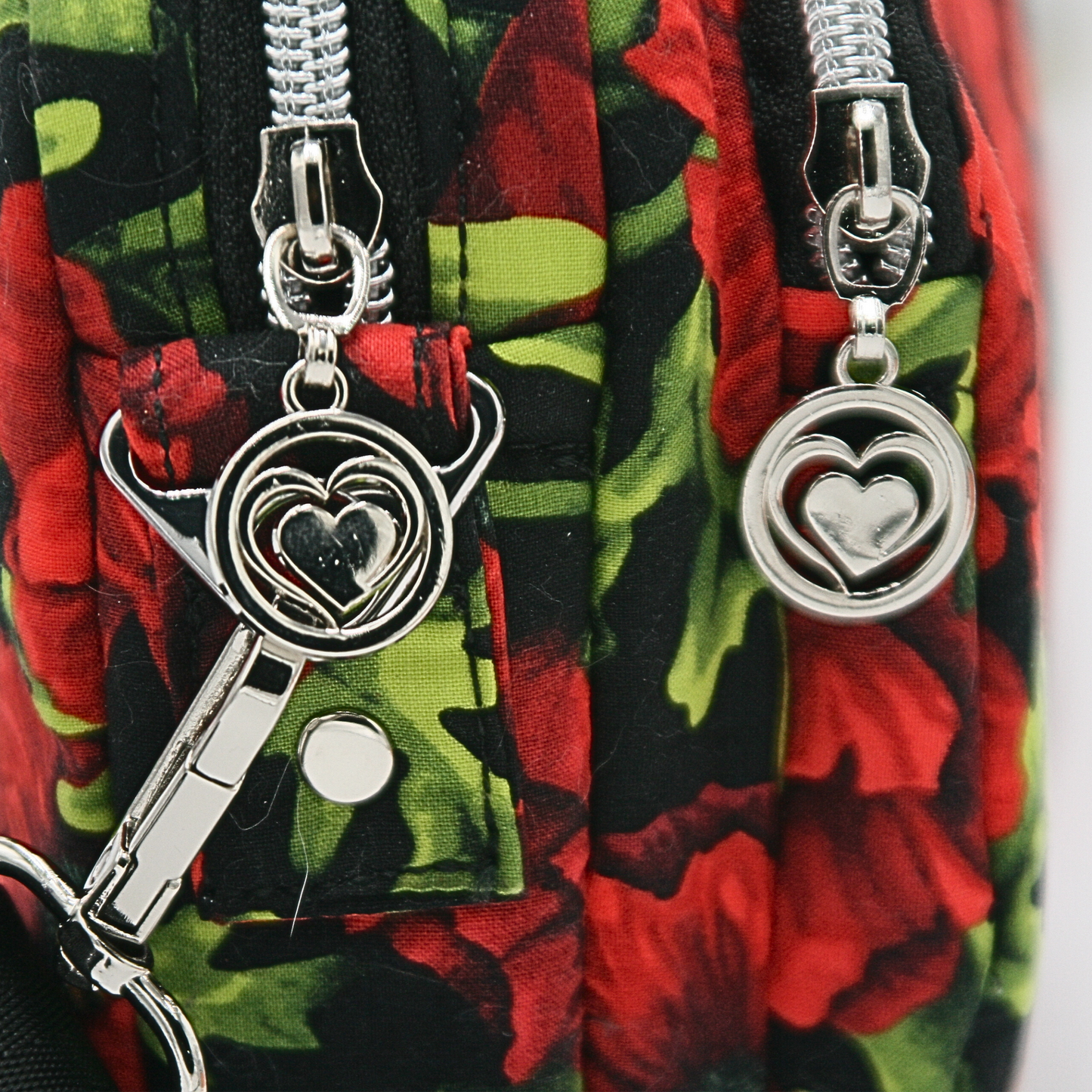 Detail of Heart Zipper Pulls
Adorned with delicate heart-shaped zipper pulls, adding a charming and unique touch to this handmade bag. Side View for Depth & Structure
Designed for convenience, this compact crossbody features a slim yet spacious 9” x 6” x 2.5” structure with dual compartments.