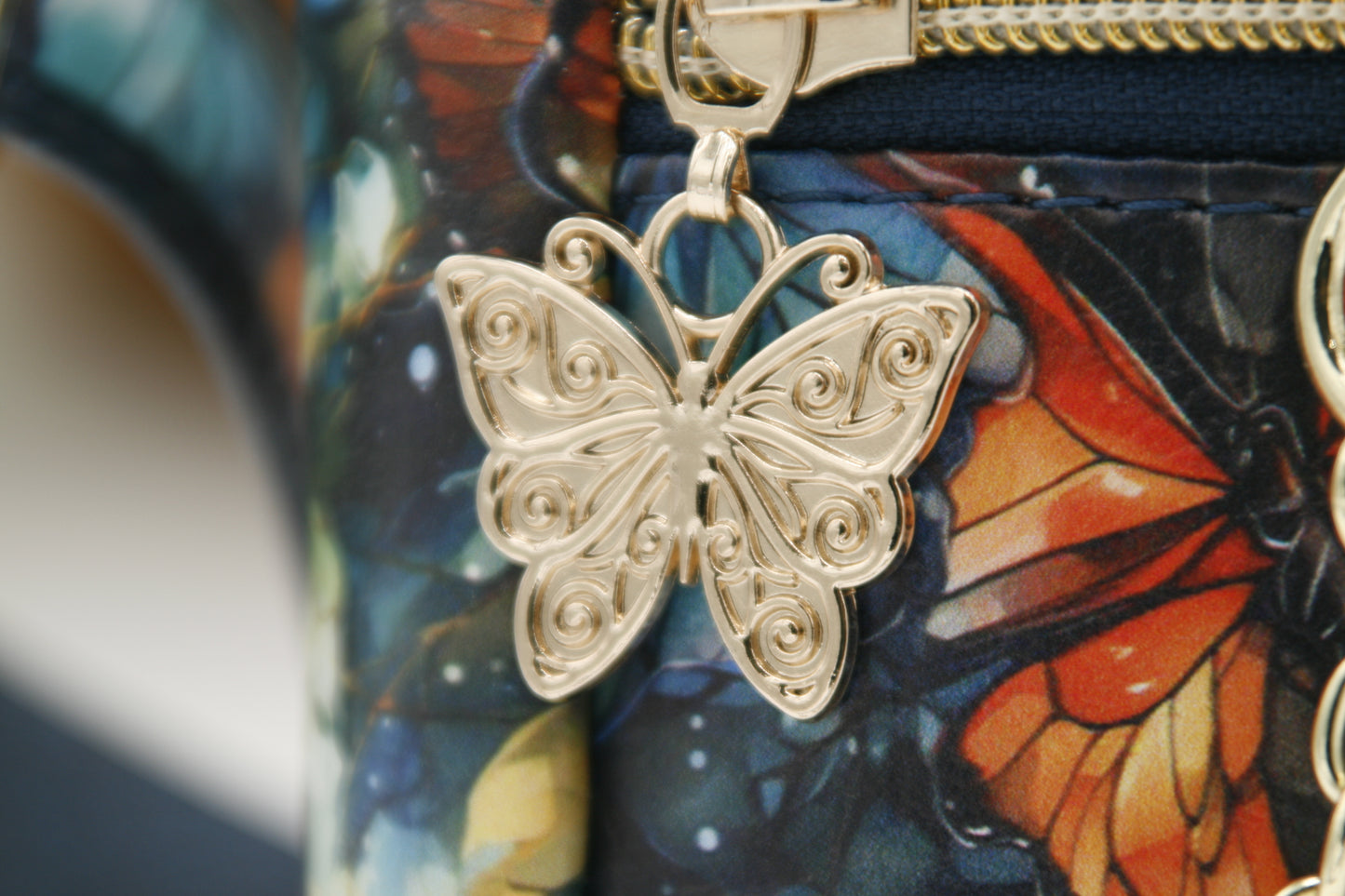 Zippers adorned with gold butterfly zipper pulls – A delicate, elegant detail that enhances the design.