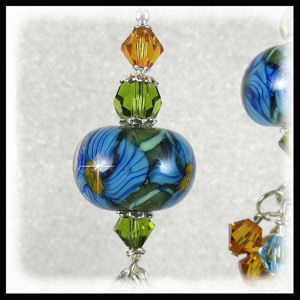 upclose look at the intricate design in the unique artisan lampwork glass bead. 2.5" dangle