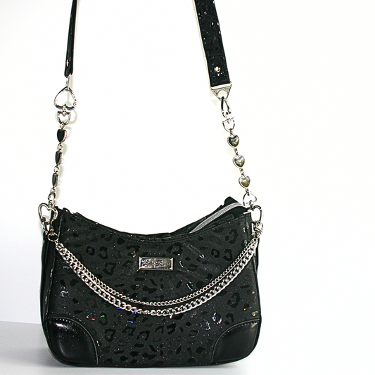 A black satin crossbody handbag with a glossy black leopard print and silver chain detail.