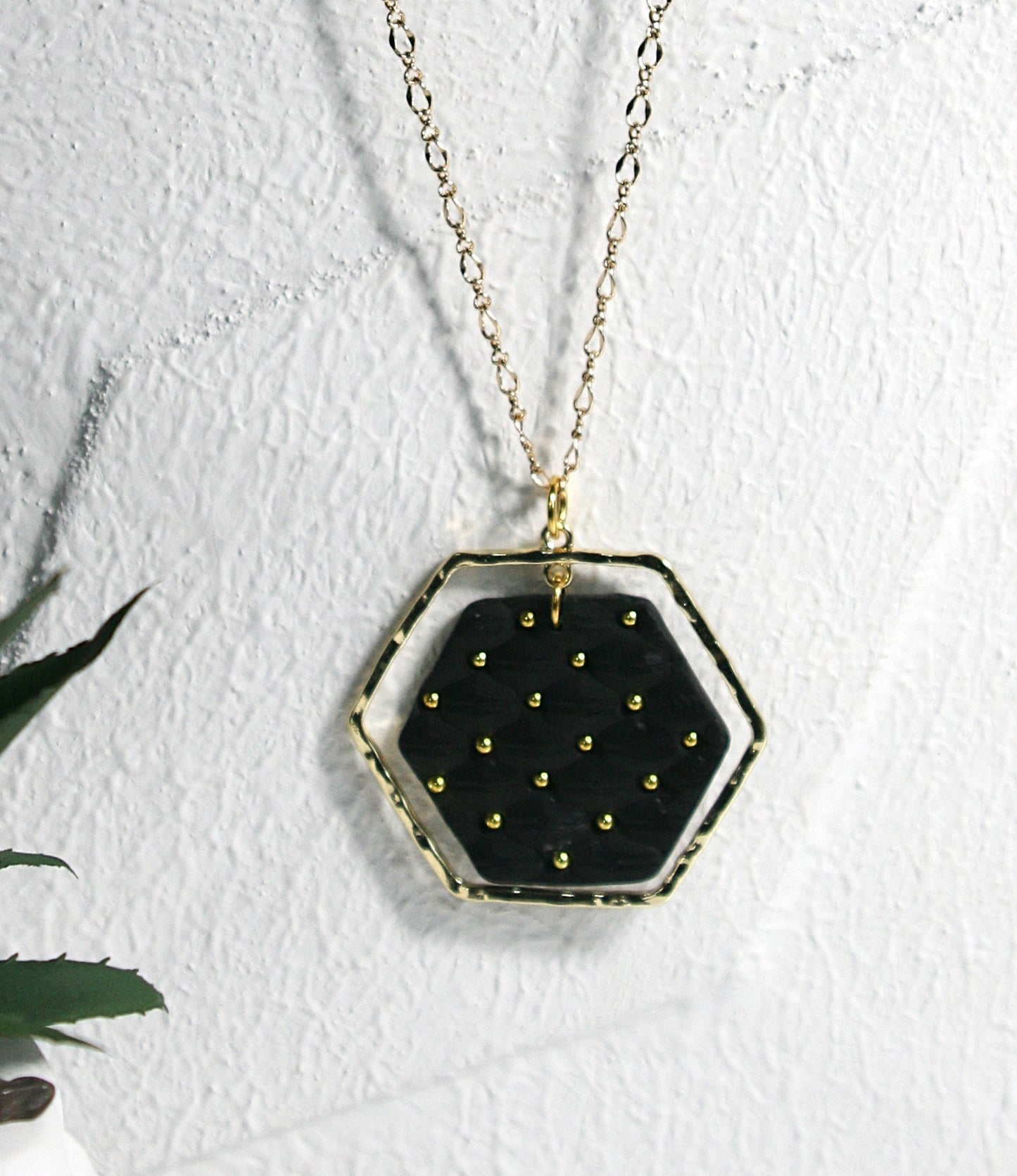 Black polymer clay pendant with gold plates frame hanging on gold plated filigree chain