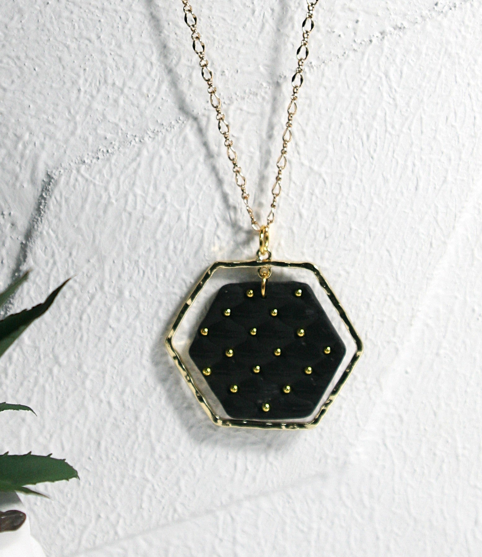 Black polymer clay pendant with gold plates frame hanging on gold plated filigree chain