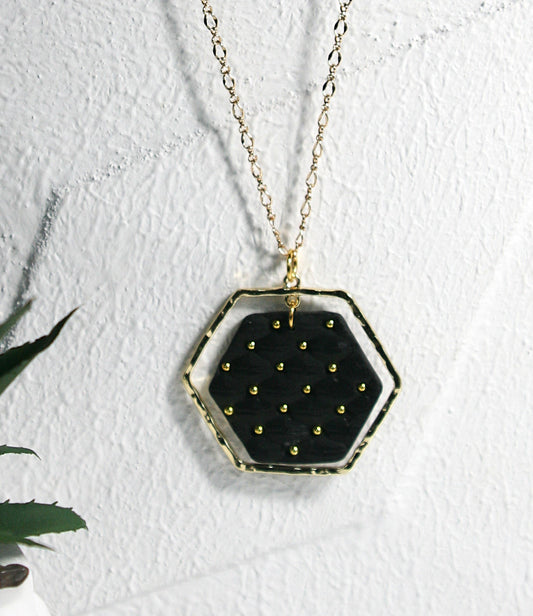 Black polymer clay pendant with gold plates frame hanging on gold plated filigree chain