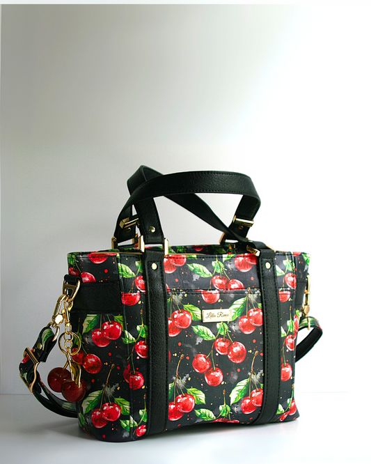 The cherries jubilee Mr. Heckles Tote bag is designed with the exclusive cherry vinyl with a front slip pocket and interior zipper pocket