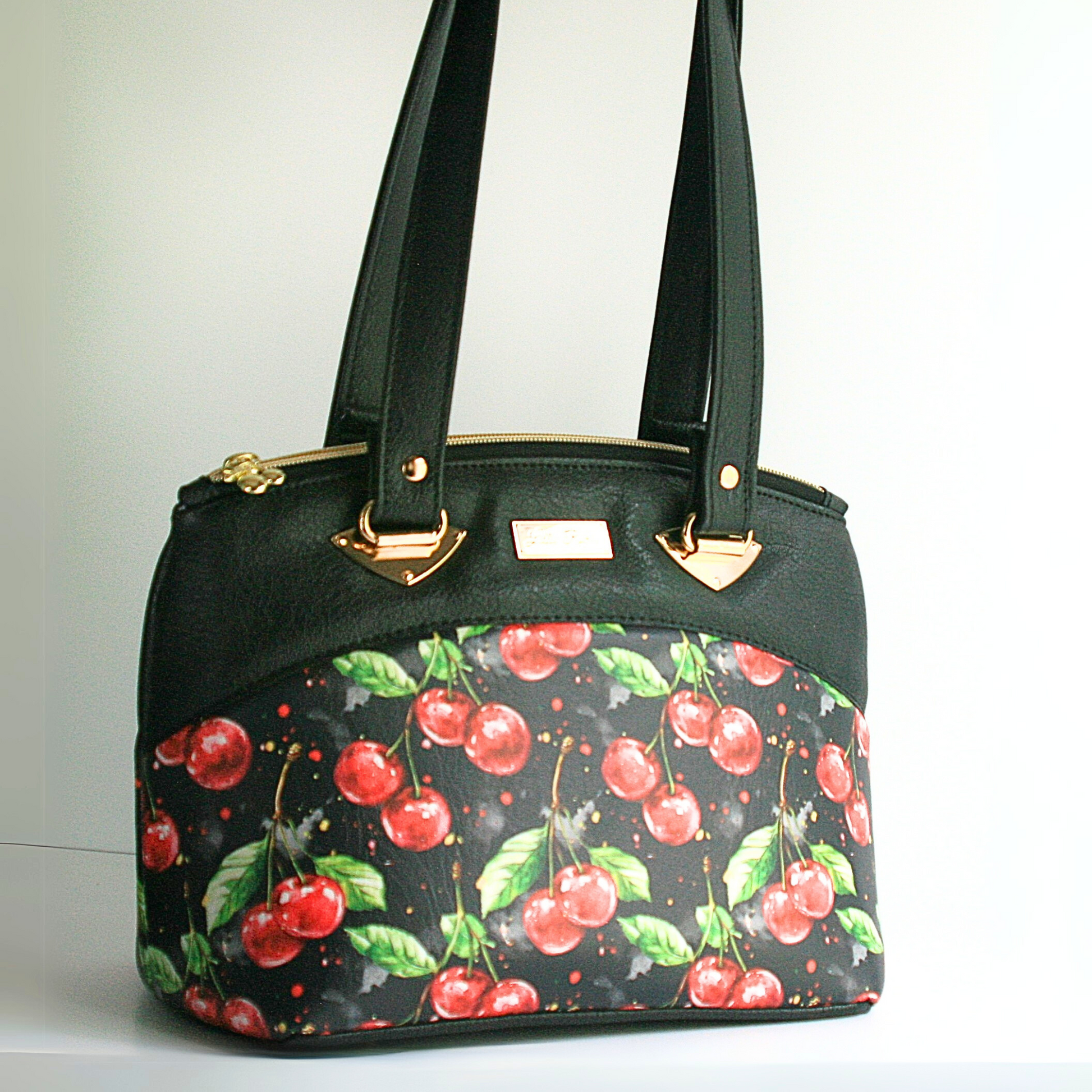 Cherries jubilee limited edition shoulder bag with gold hardware and top zipper closure"