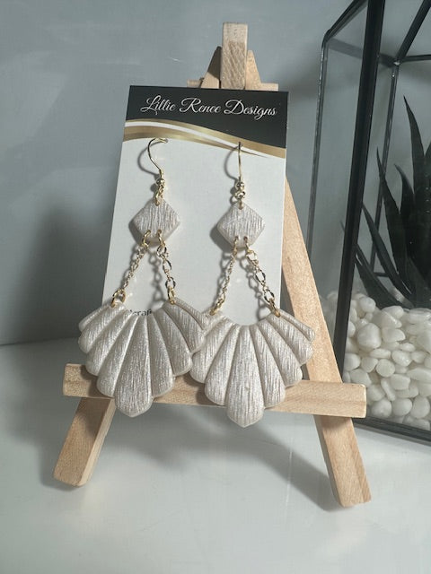 Ivory textured fan polymer clay earrings on gold plated chains. 3" long earrings