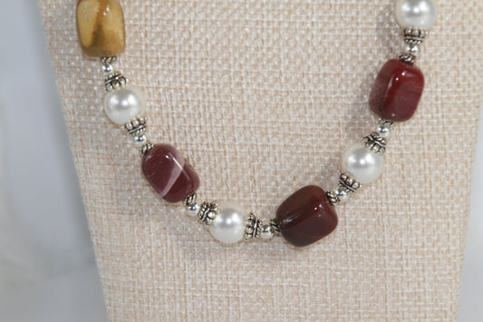 25-inch necklace featuring burgundy, mustard, and cream Mookaite gemstones, white Swarovski pearls, and sterling silver accents with extender chain.

