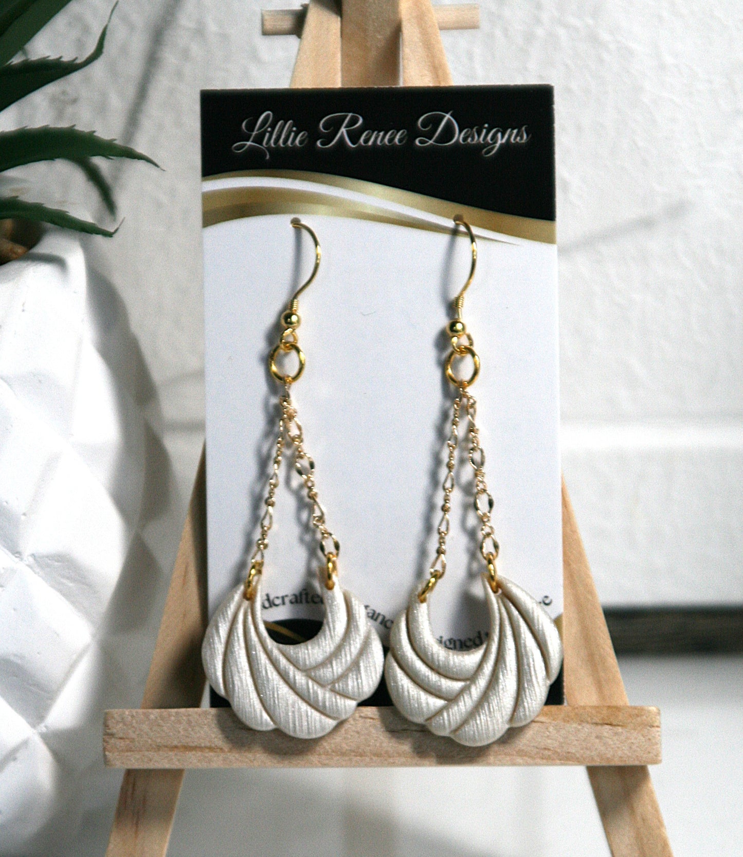 Stunning ivory shimmering polymer clay hanging from gold plated filigree chain.