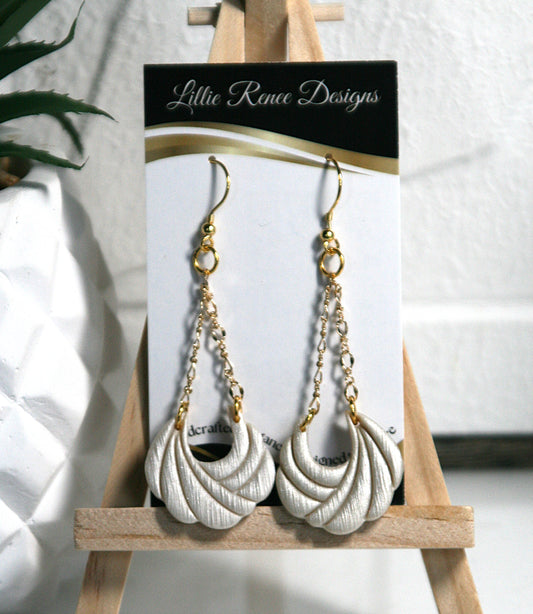 Stunning ivory shimmering polymer clay hanging from gold plated filigree chain.