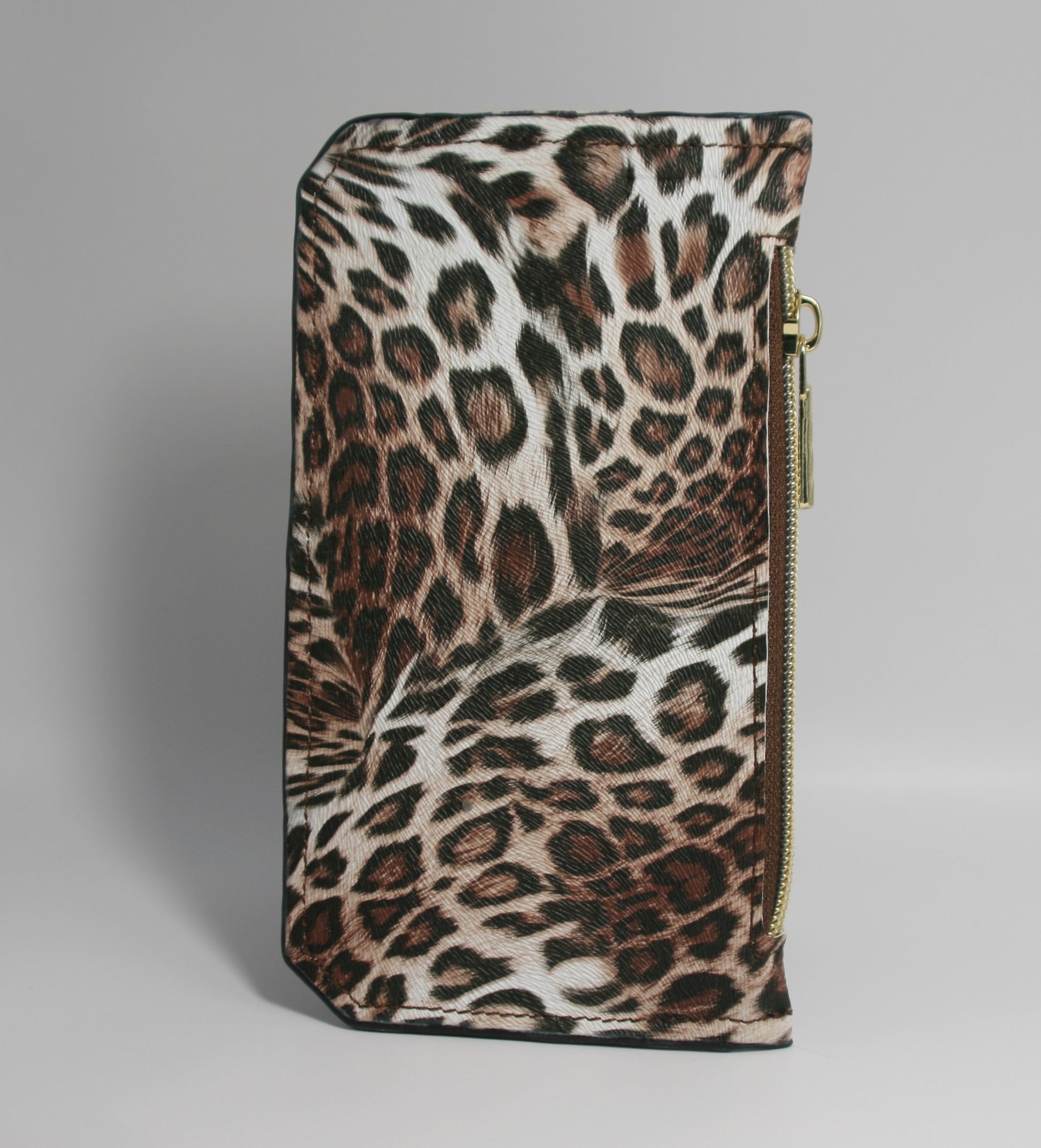 Brown leopard print vinyl Purse Pal slim wallet featuring six card slots secured with a snapped flap, a cash slip pocket, and a zippered coin pocket. Designed for both style and functionality, this compact wallet is accented with gold hardware for a chic, trendy look.