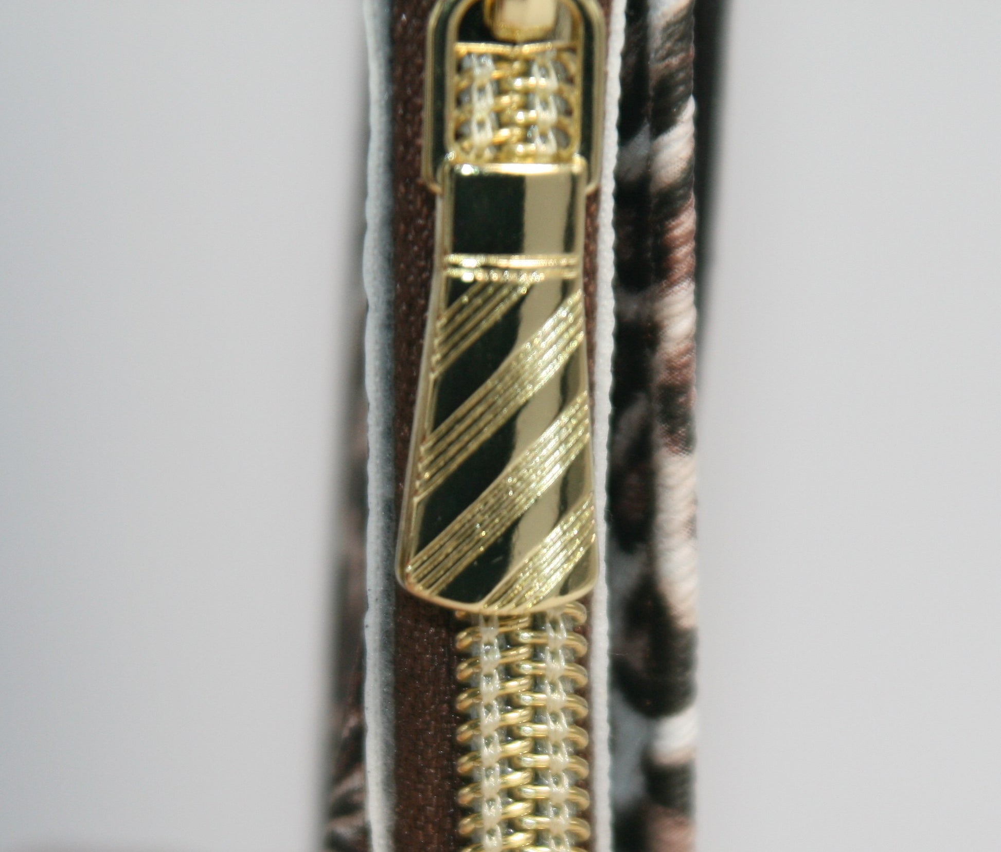 Designed for both style and functionality, this compact wallet is accented with gold hardware for a chic, trendy look. 