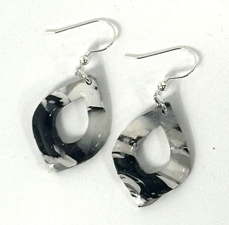 Black and white marbled earrings on a white background