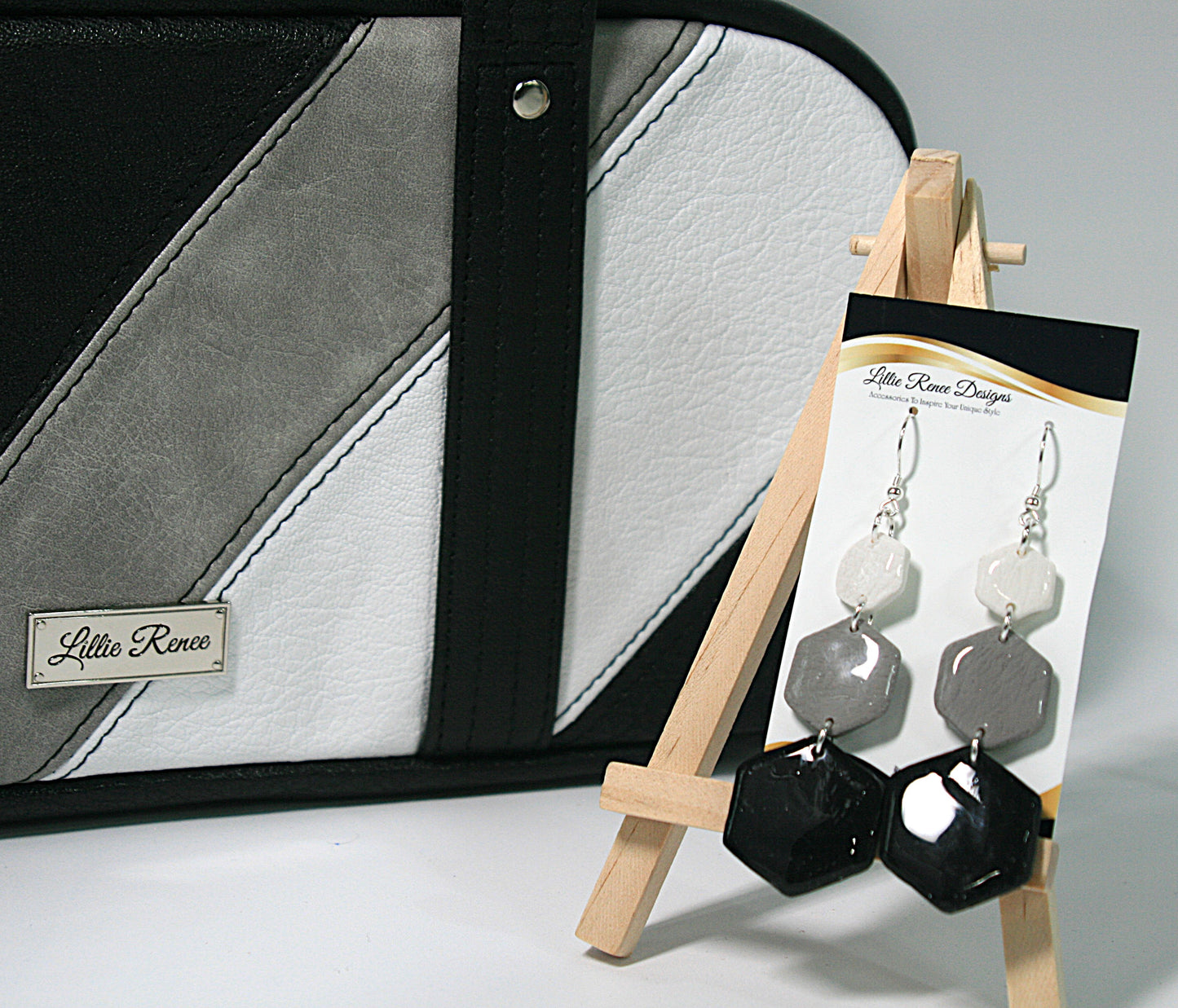 Neutral-toned earrings displayed with coordinating Frosted Obsidian purse