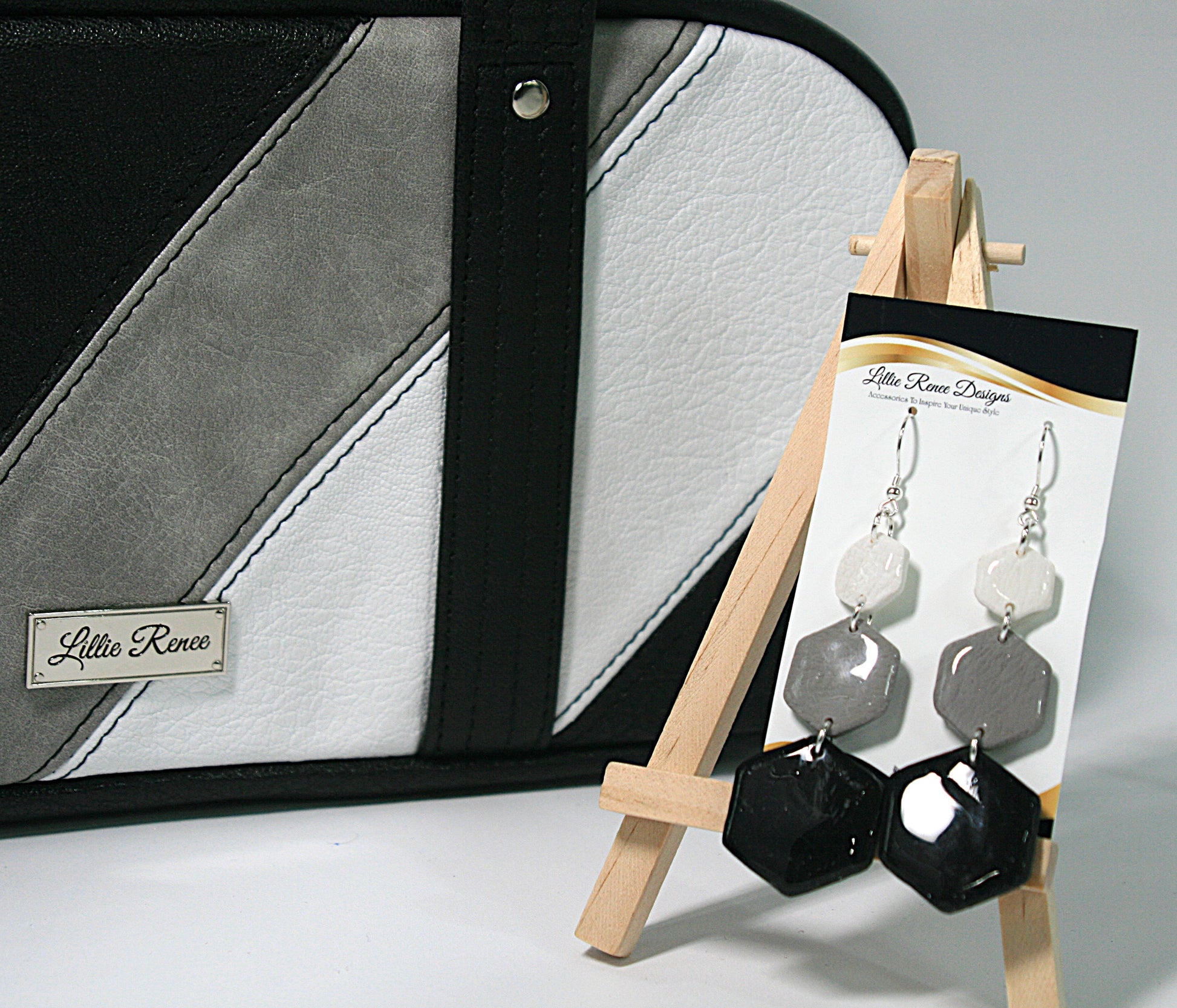 Neutral-toned earrings displayed with coordinating Frosted Obsidian purse