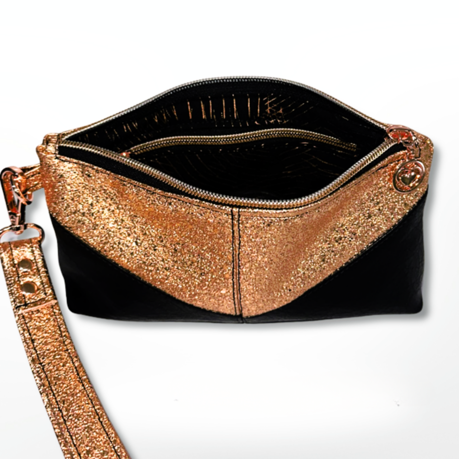 Copper vinyl and black faux leather Harlequin wristlet, featuring a sleek and stylish design. The interior boasts a cotton copper and black lining, an interior zip pocket, and rose gold heart zipper pulls for a chic, elegant touch. Accented with rose gold hardware, this wristlet is perfect for carrying essentials in style.