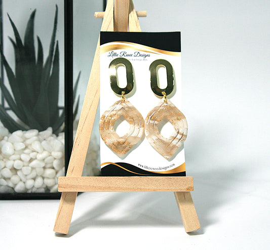 Pair of gold hoop earrings on a display card with 'Little Rose Designs' branding, placed on a small wooden easel.