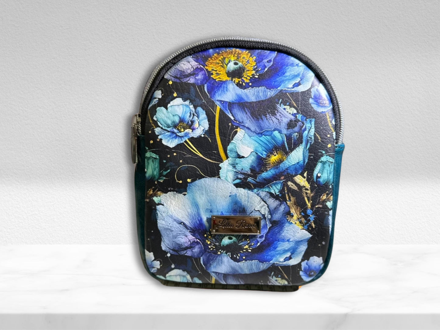 Small backpack with a one adjustable strap sling. Designed in a beautiful blue poppies vinyl