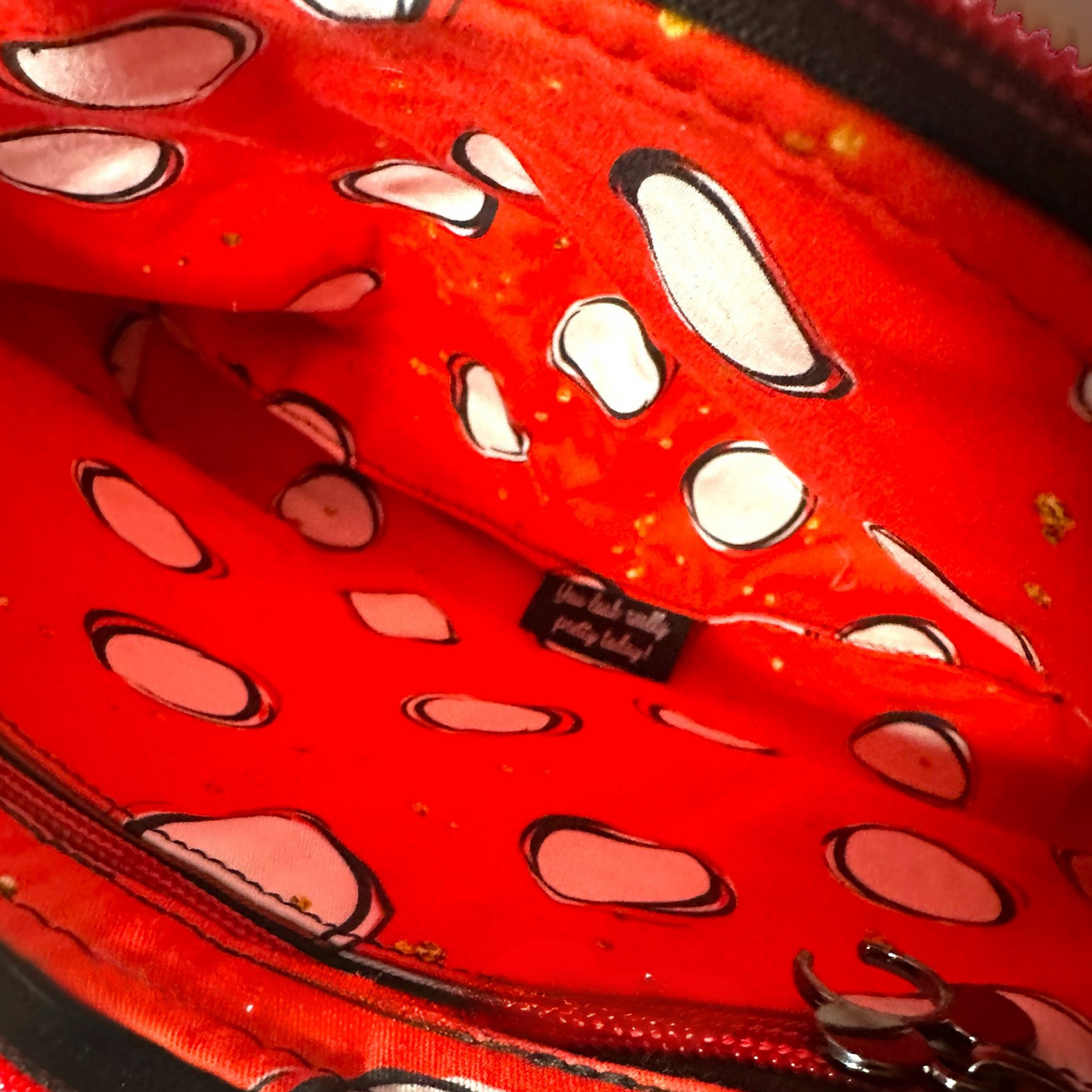 Mickey-inspired animal print crossbody bag with a black canvas exterior and a coordinating red and white cotton interior lining. This medium-sized crossbody purse features an interior zipper pocket, exterior zipper pocket, and an adjustable crossbody strap for hands-free convenience. Perfect for Disney fashion lovers, travel bags, theme park accessories, and everyday use.