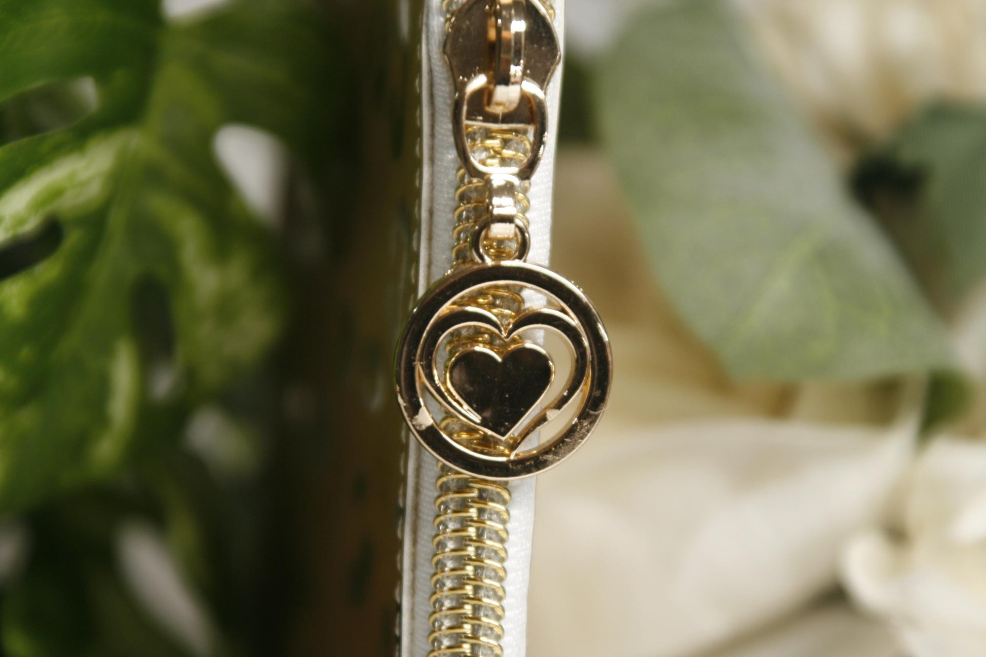 gold zipper pull on gold metallic wallet